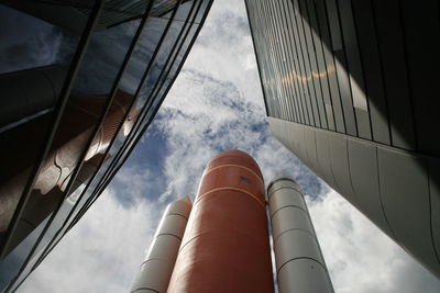 Low angle view of rocket against cloudy sky in kennedy space center