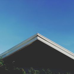 Low angle view of built structure against clear blue sky