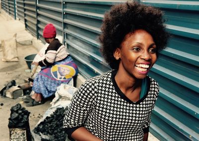 Portrait of smiling young woman sitting outdoors