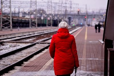 Rear view of woman on railroad station platform