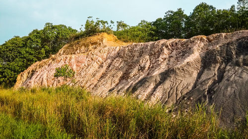 Scenic view of rocks on land against sky