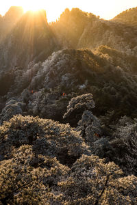 Rocks on mountain against sky during sunset