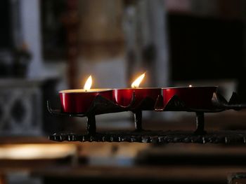 Close-up of lit candles in temple