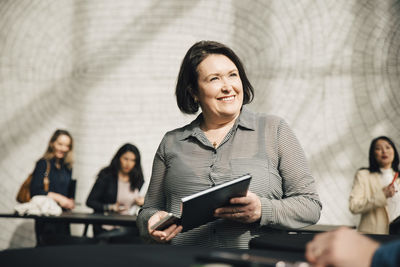 Smiling businesswoman looking at businessman during meeting in office