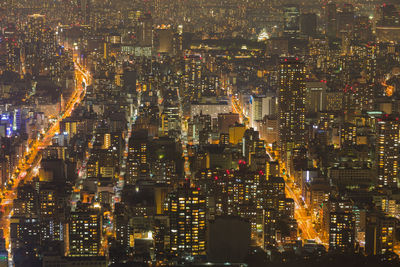 High angle view of illuminated city buildings at night