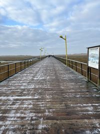 Pier over sea against sky