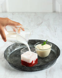 Pour milk to glass with strawberry compote fresh korean strawberry milk 