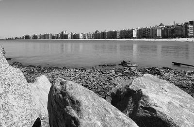 View of city by river against clear sky