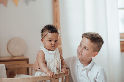 Portrait of cute boy looking at home