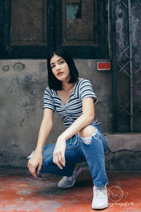 Full length of woman sitting outdoors