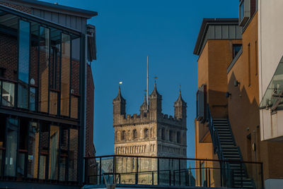 Low angle view of buildings against blue sky