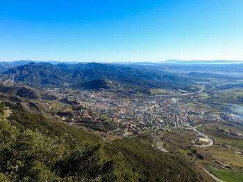 High angle view of landscape against clear blue sky