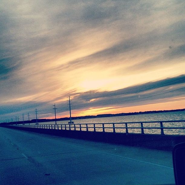 sunset, sky, water, sea, tranquility, tranquil scene, scenics, cloud - sky, beauty in nature, railing, orange color, nature, connection, idyllic, pier, cloud, the way forward, horizon over water, bridge - man made structure, cloudy