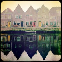 Building reflecting in water