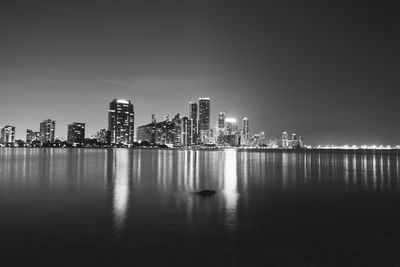 Illuminated city at waterfront