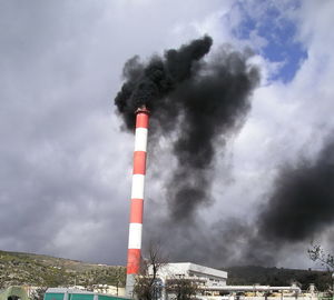 Low angle view of lighthouse against cloudy sky