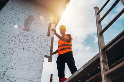 Low angle view of young man standing on steps