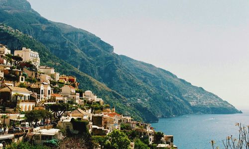 High angle view of sea and mountains against clear sky