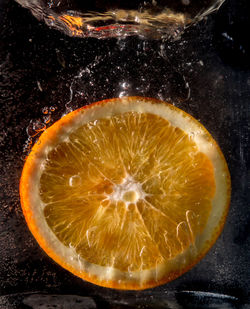 Close-up of lemon slice over black background