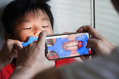 Portrait of boy holding mobile phone