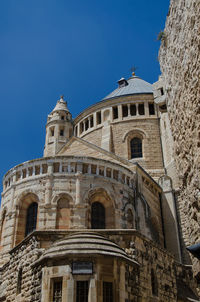 Low angle view of historical building against blue sky