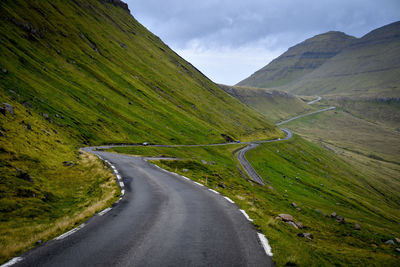 Scenic view of road amidst mountains against sky