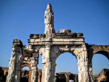 Low angle view of historic anfiteatro campano against clear sky