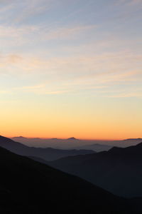 Scenic view of silhouette mountains against sky during sunset