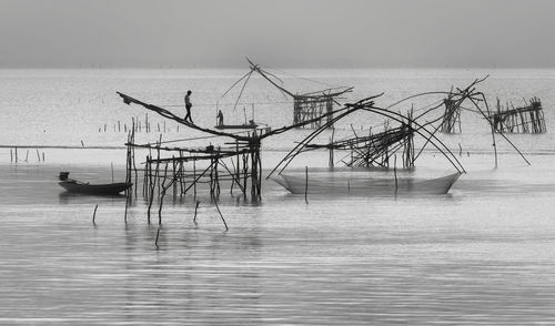 Fishing net on sea against sky