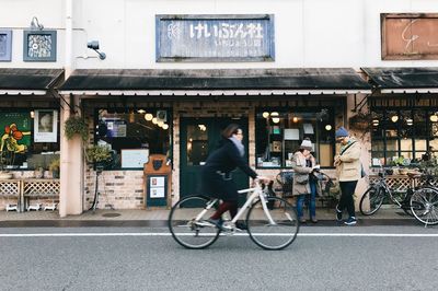 People riding bicycle on street