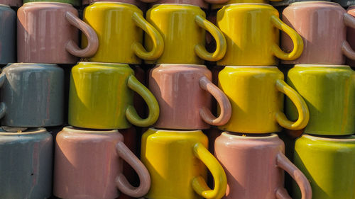 Full frame shot of multi colored stacked cups for sale at market