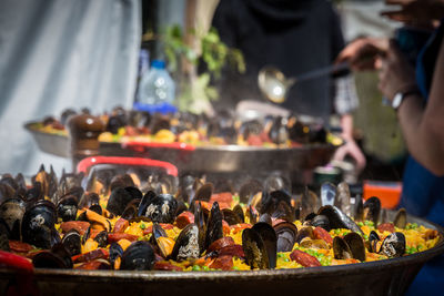 Close-up of man preparing food at market stall