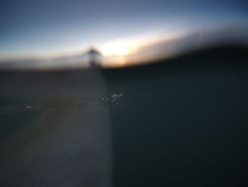 Close-up of water against sky during sunset