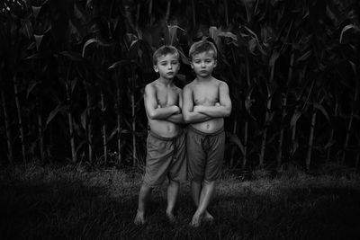 Portrait of shirtless boy standing on field