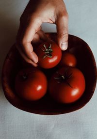 Midsection of man holding fruit