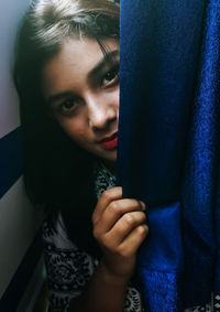 Close-up portrait of young woman holding hands