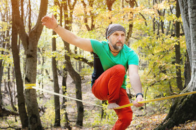 Full length of man standing in forest