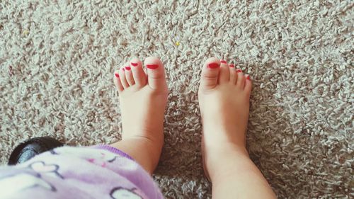 Low section of baby girl with nail polish on toenails