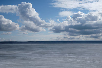 Scenic view of clouds over landscape. iced river in early spring
