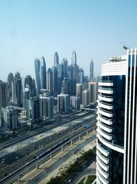 Modern buildings in city against clear sky