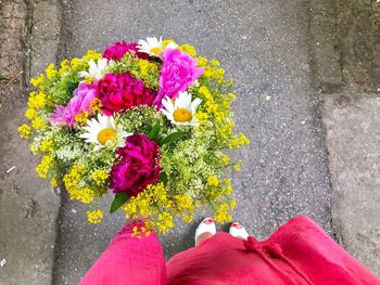 Low section of person by flower bouquet