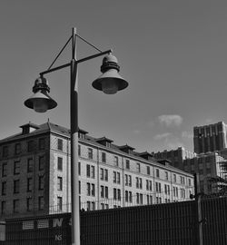 Low angle view of street light against building