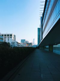Street amidst buildings against clear sky