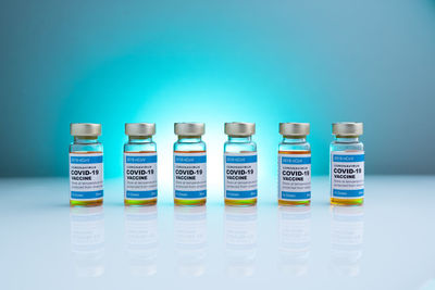 Close-up of bottles against blue background