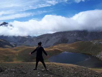 Full length of man standing on mountain against sky