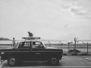 Car on beach against sky