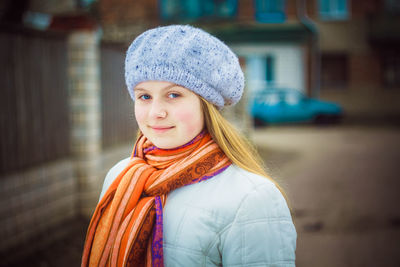 Portrait of woman standing in city during winter