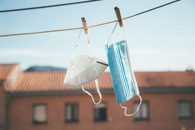 Low angle view of clothes hanging on clothesline against building