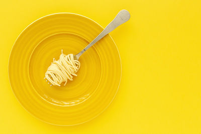 Directly above shot of ice cream against yellow background