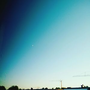 Low angle view of moon against blue sky